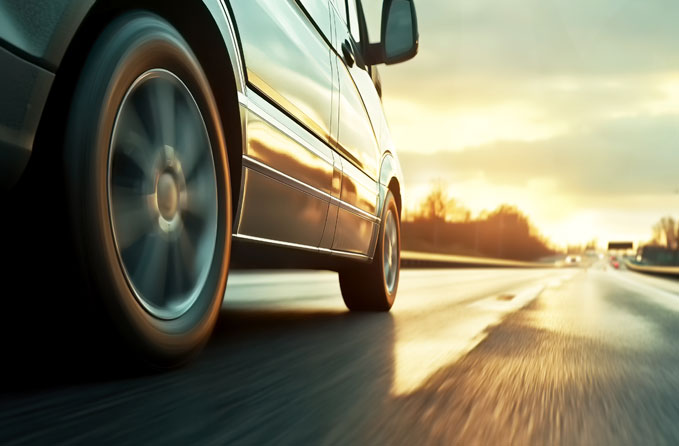 shuttle-service car driving down the highway